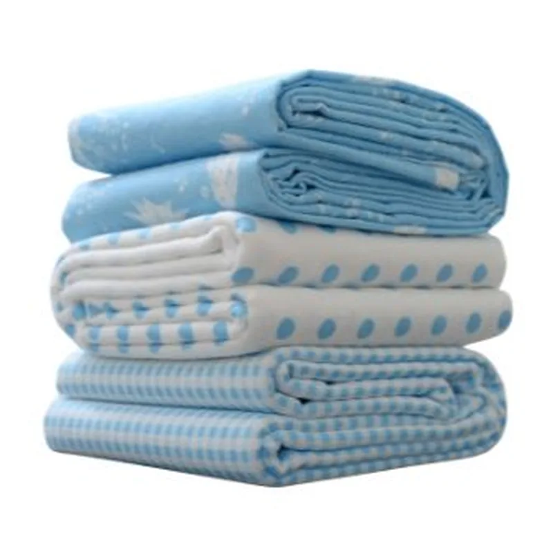 A stack of folded blue nursery blankets on a white background