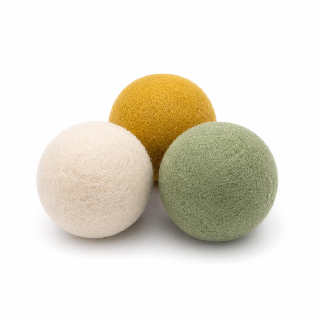 Three soft wool felt play balls on a white background